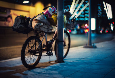 Man riding bicycle on street at night