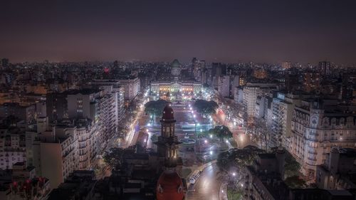 High angle view of palacio del congreso and buildings in city at night