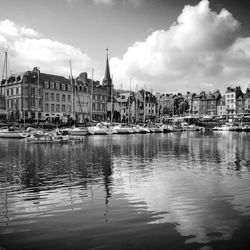 Boats in river with buildings in background