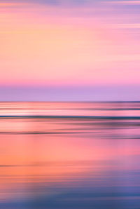 Scenic view of sea against romantic sky at sunset