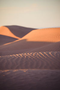 Scenic view of desert against sky during sunset