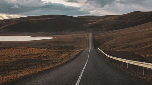 Empty road leading towards mountains