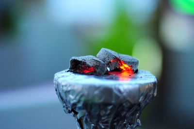 Close-up of burning candle on wood