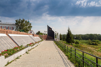 Rear view of man walking on road against sky