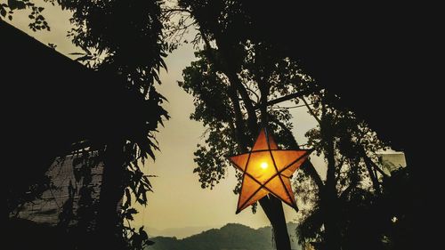 Low angle view of illuminated street light against sky at night