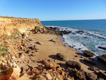 Scenic view of beach against clear sky