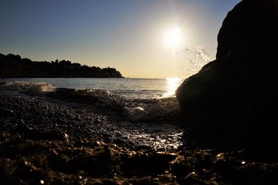 Close-up of sea against sky at sunset