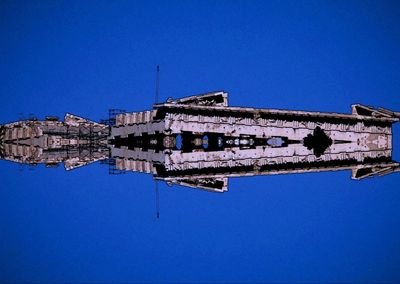 Low angle view of buildings against clear blue sky