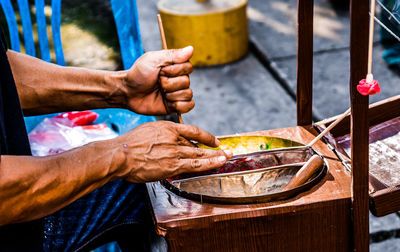 Midsection of man preparing food