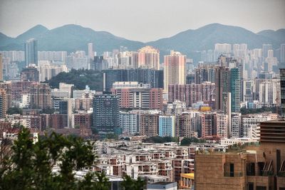 Aerial view of buildings in city against clear sky