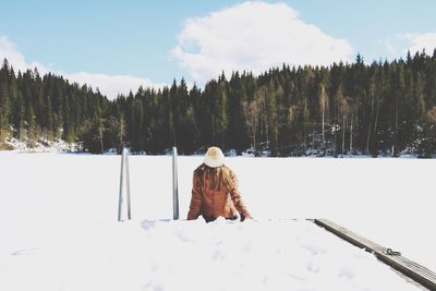 Rear view of man on snow covered landscape