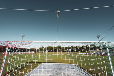 Low angle view of soccer field against clear sky