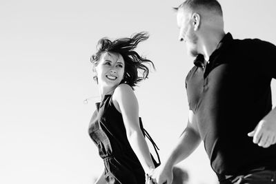 Young woman looking away against white background