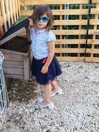 Portrait of cute girl wearing sunglasses in yard