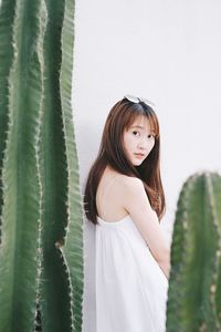 Portrait of woman seen through cactus