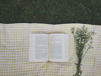 High angle view of open book on field