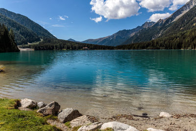 Scenic view of lake by mountains against sky