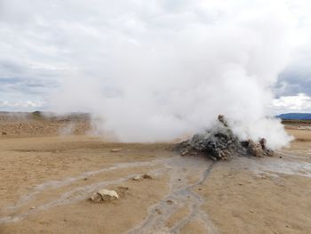 Panoramic view of geyser on landscape