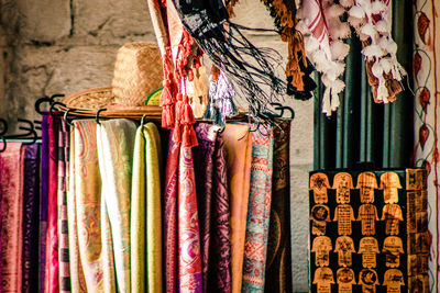 Various clothes hanging in store for sale in market