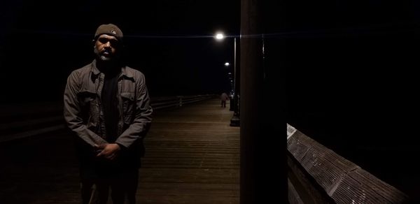 Young man looking away at night