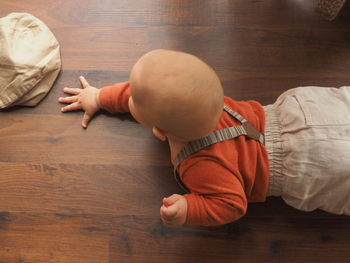 High angle view of cute baby relaxing on floor at home