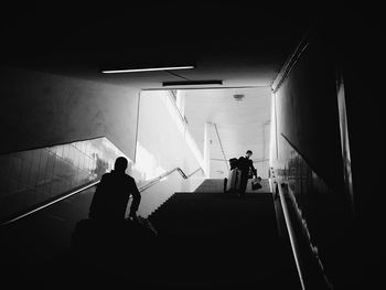 Low angle view of people walking on stairs in subway