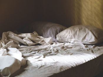 Pillows on messy bed at home