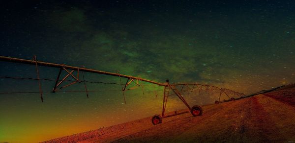 Low angle view of crane against sky at night