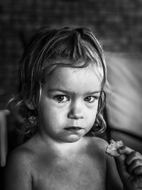 Portrait of cute girl holding cookie