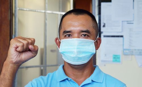 Men wear masks to prevent germs at home.