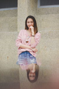Multiple image of smiling woman standing against wall