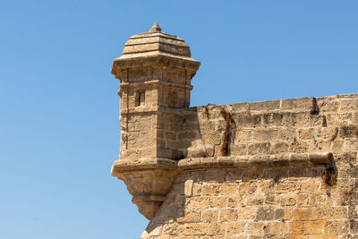 Low angle view of historical building against clear blue sky