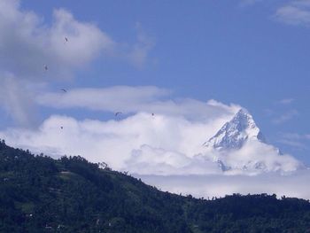 Scenic view of mountains against cloudy sky