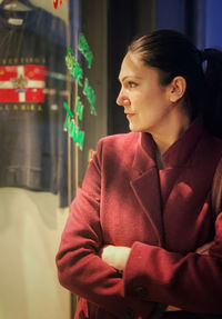 A young woman in front of a shop, shopping, city, elegant, stylish, cold temperature, glass material