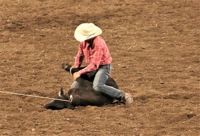 Full length of man wearing hat on field
