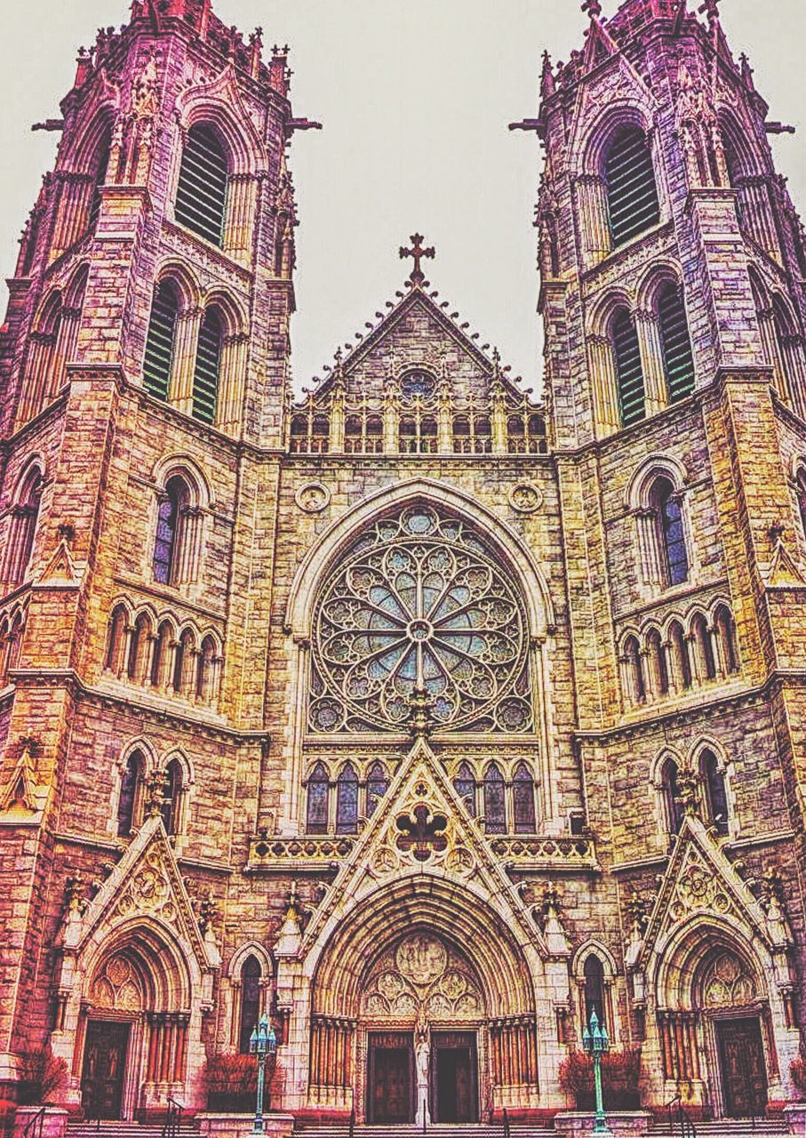 religion, place of worship, arch, architecture, church, spirituality, building exterior, built structure, low angle view, facade, cathedral, ornate, gothic style, entrance, history, architectural feature, day, rose window, outdoors, arched, exterior, culture, arcade, national landmark, archway