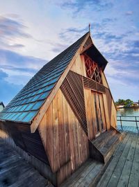 Low angle view of wooden house against sky