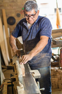 The elder or senior learn new skills, learn to become a carpenter