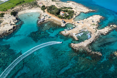 Aerial drone of fishing speed boat entering and moored at the harbor.