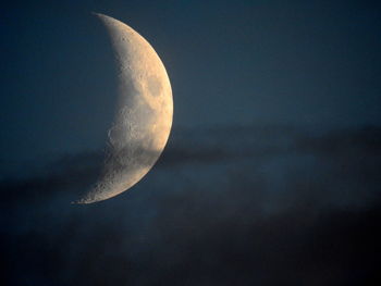 Low angle view of half moon against sky at night