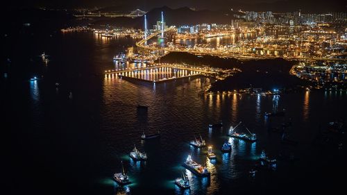 River by illuminated city at night