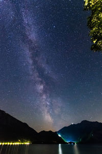 Scenic view of lake against star field at night in bavaria