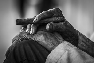 Close-up of senior man holding cigar