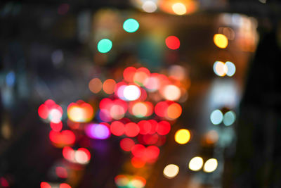 Defocused image of illuminated christmas lights at night