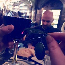 Close-up of man holding wineglass