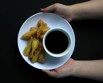 Midsection of person holding breakfast