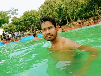 Portrait of young man in swimming pool