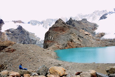 Scenic view of lake and rocks against sky