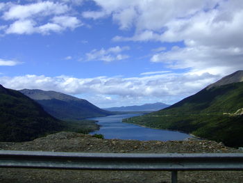 Scenic view of river and mountains against sky