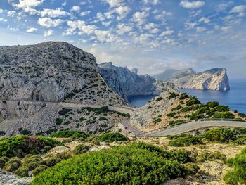 Scenic view of sea and mountains against sky